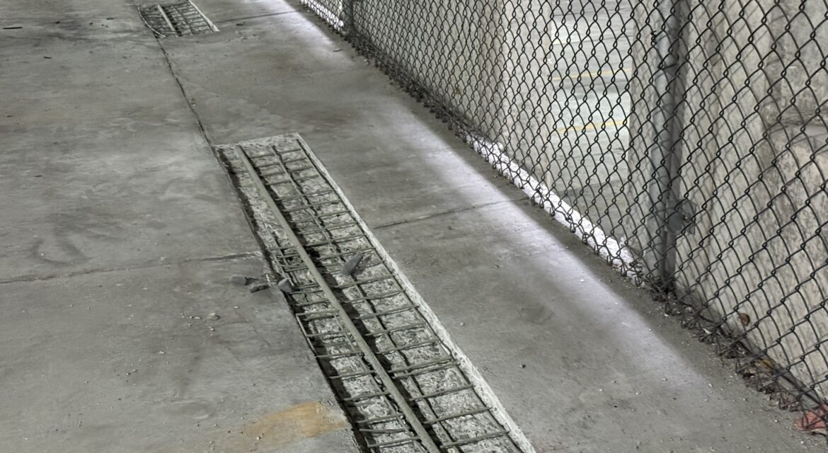 Parking garage concrete floor slab repair with reinforcing steel exposed