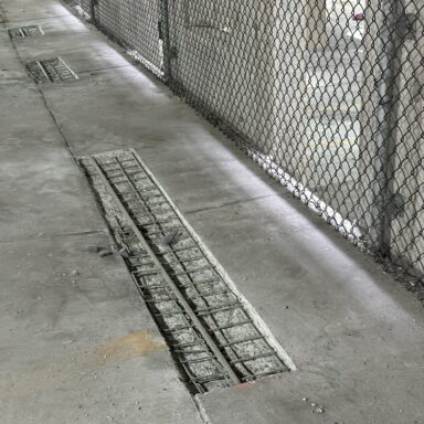 Parking garage concrete floor slab repair with reinforcing steel exposed