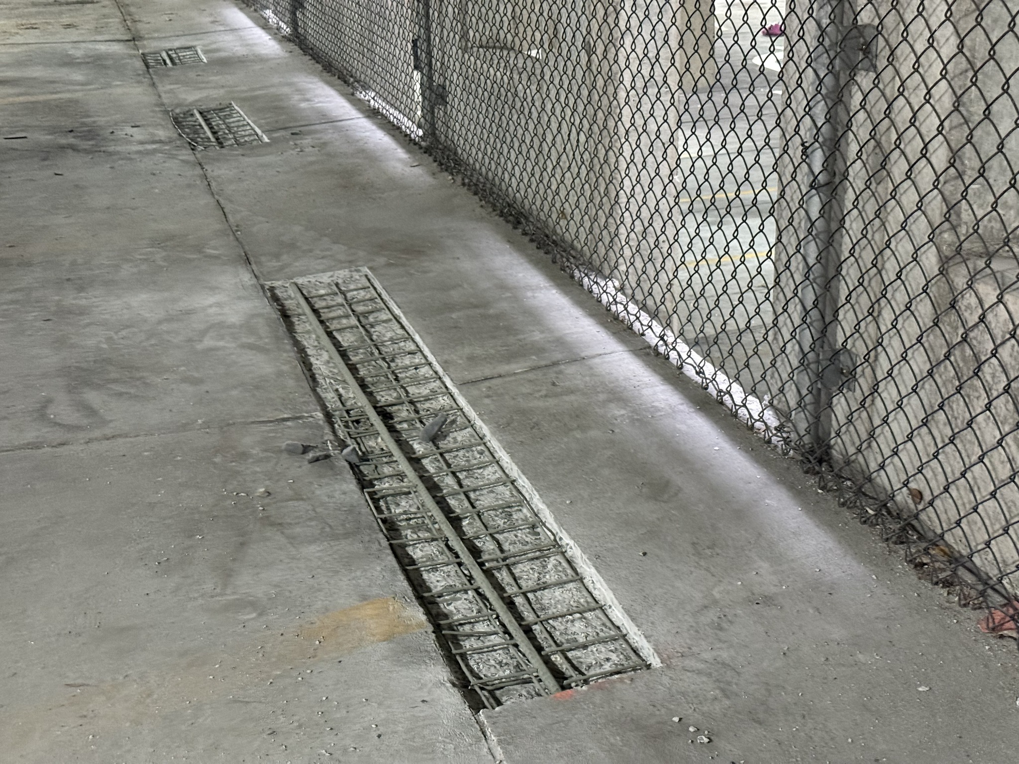 Parking garage concrete floor slab repair with reinforcing steel exposed