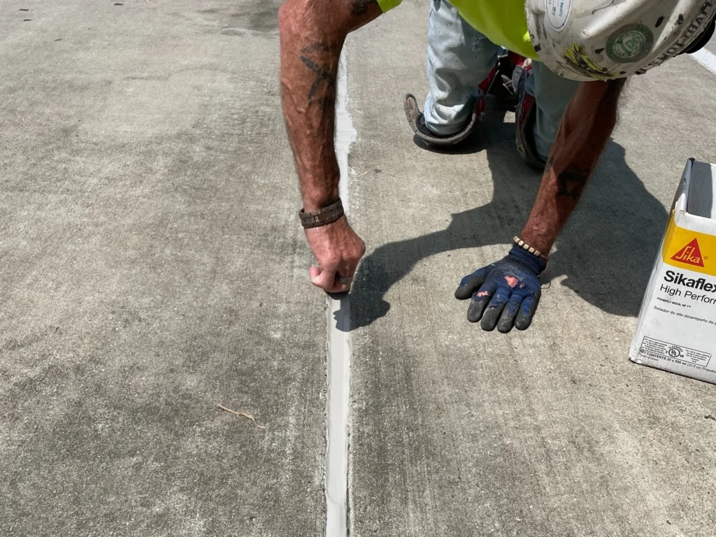 Contractor tooling new parking deck joint sealant at the Porter Building in Charlotte