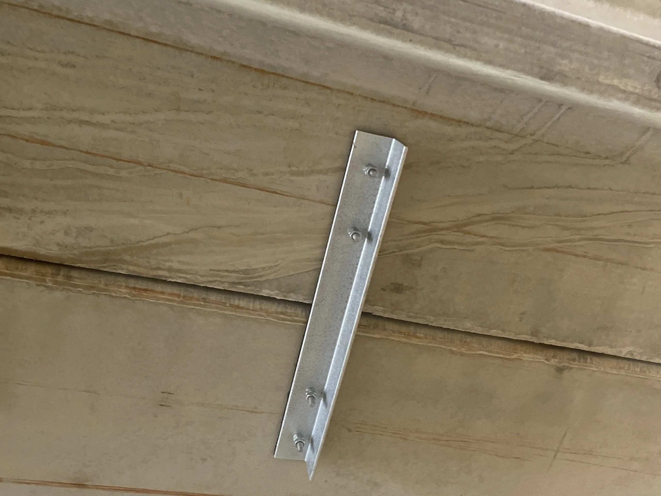 Galvanized supplemental shear connector installed between precast double tees at the Porter Building